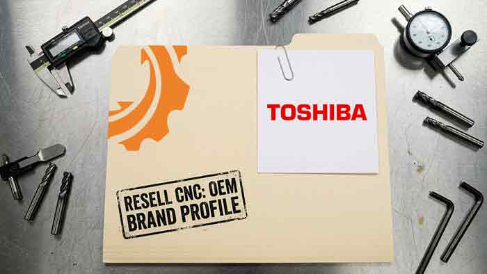 Toshiba logo clipped to a Resell CNC brand profile folder on a steel bench with calipers, end mills and a dial indicator